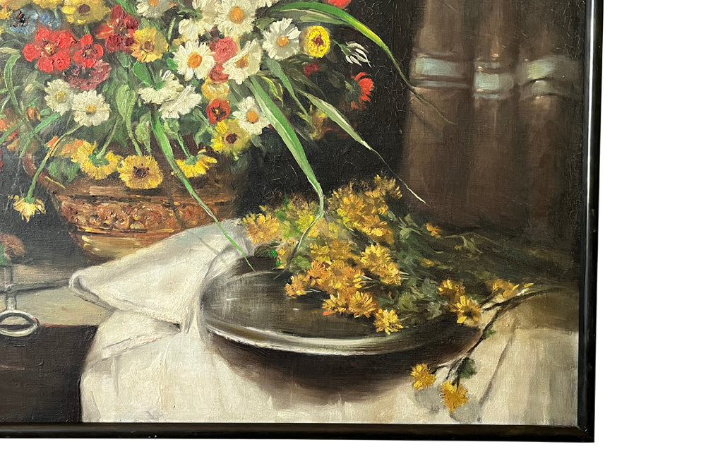 19th Century still life painting of flowers in a florist setting with draped table and backdrop. This joyous oil on canvas has been beautifully relined and framed in a simple black frame. It is signed Valdeg - AD & PS Antiques