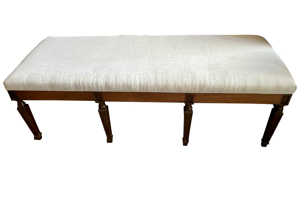 Large early 20th Century French walnut banquette in the Neo-Classical style.