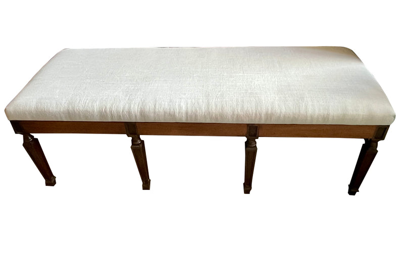 Large early 20th Century French walnut banquette in the Neo-Classical style.