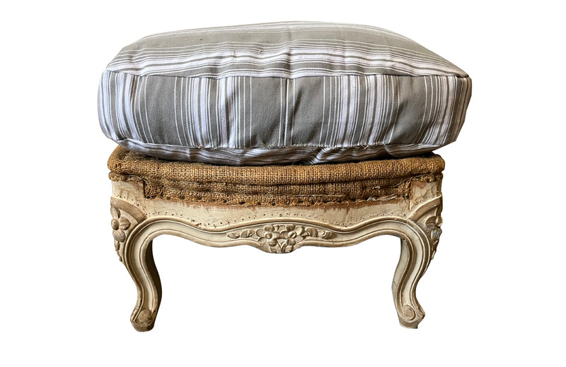 Large French footstool in the Louis XV style with feather-filled cushion upholstered in ticking. 