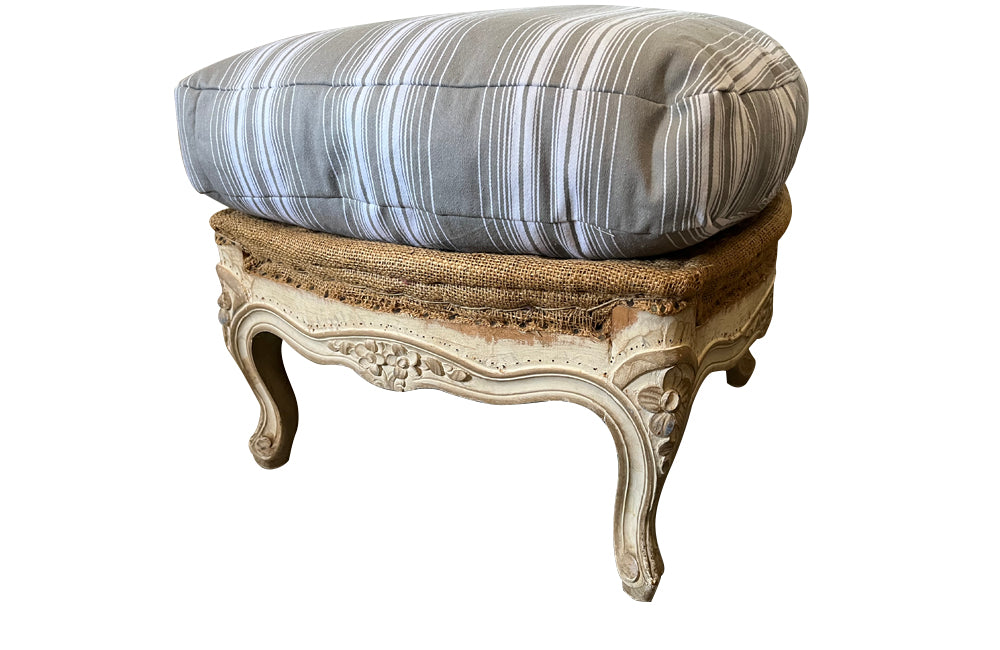 Large French footstool in the Louis XV style with feather-filled cushion upholstered in ticking. 