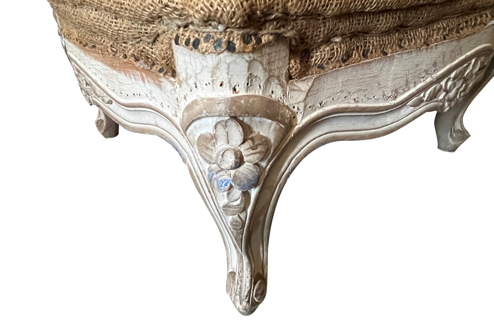 Large French footstool in the Louis XV style with feather-filled cushion upholstered in ticking. 