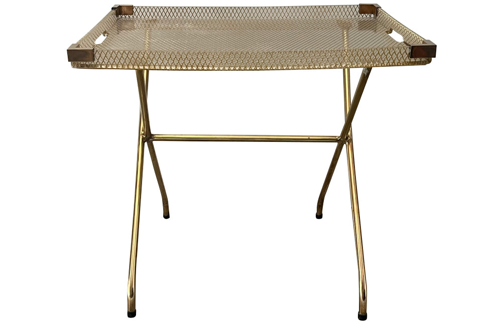 Large lucite tray with brass corners and embedded mesh with two incorporated handles sitting on a separate brass stand.