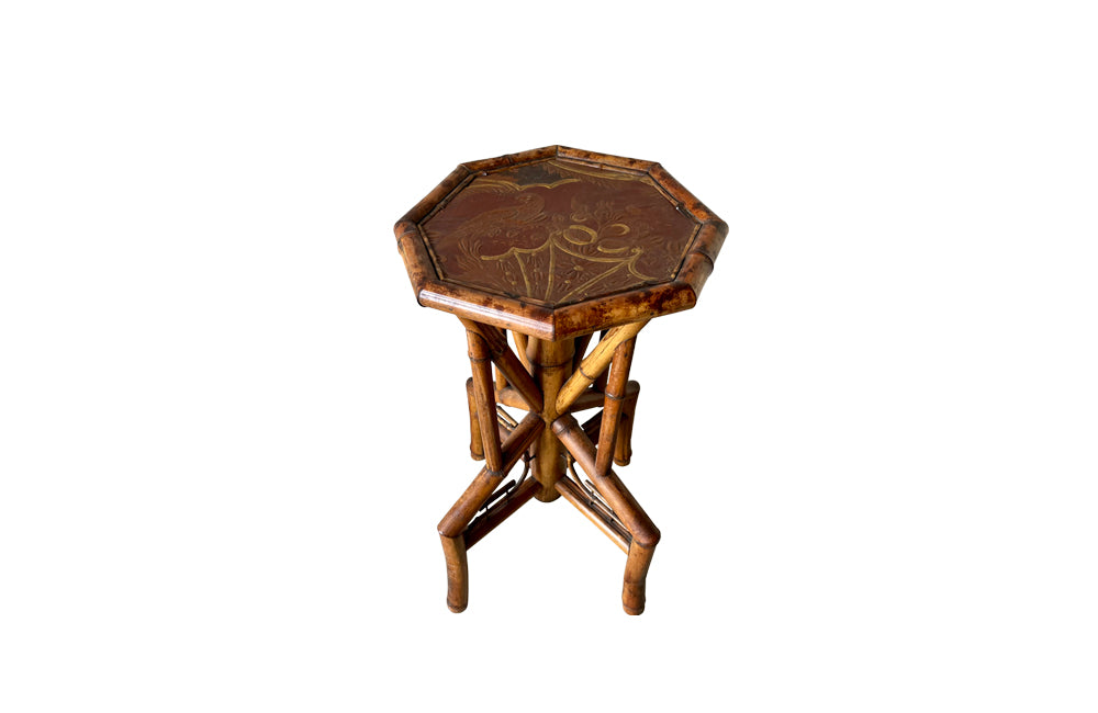 Aesthetic Movement bamboo occasional table with leathered Chinoiserie top embossed with a parrot, floral and foliate decoration. Circa 1900