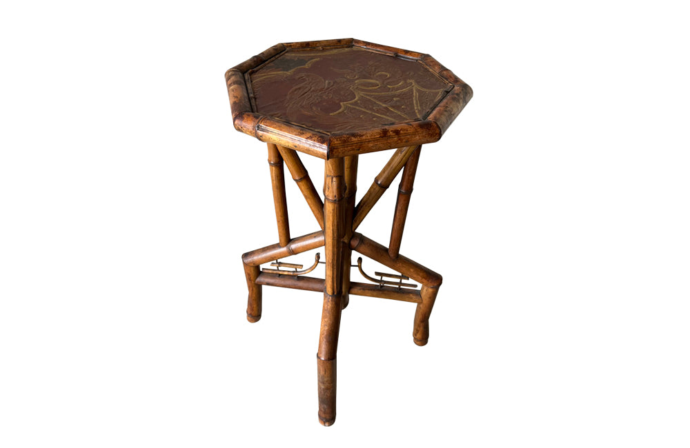 Aesthetic Movement bamboo occasional table with leathered Chinoiserie top embossed with a parrot, floral and foliate decoration. Circa 1900
