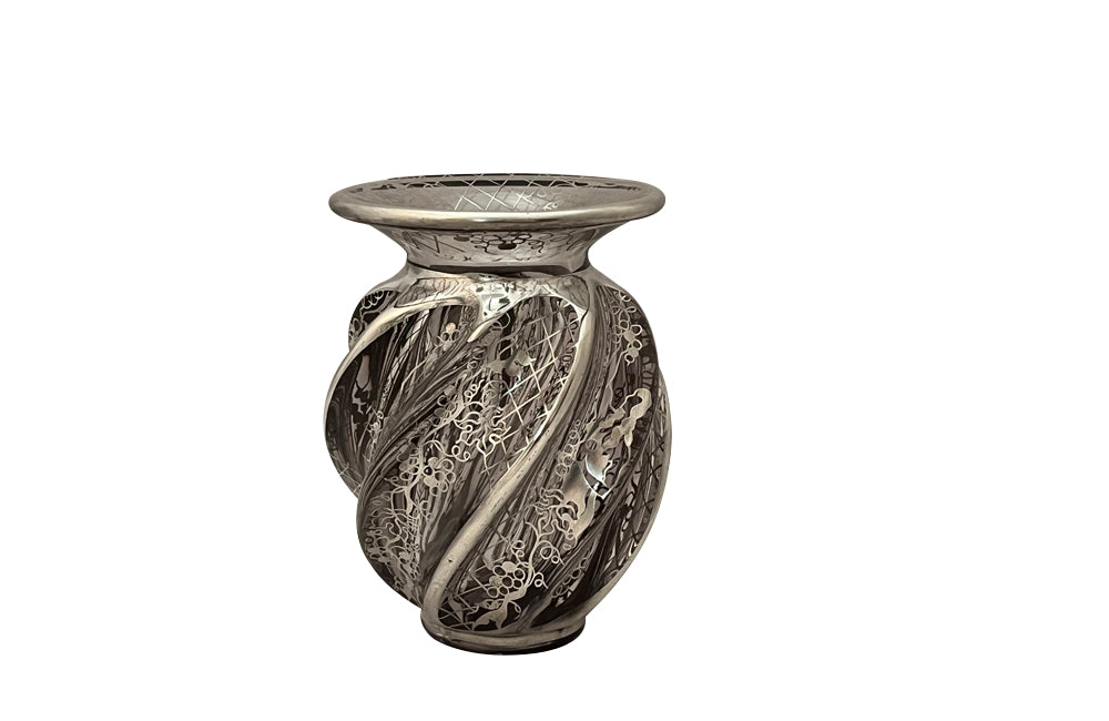 Beautiful mid century crystal vase with silver overlay by the renown French glass makers Saint Graal of swirl form decorated with grape vine and trellis motifs.