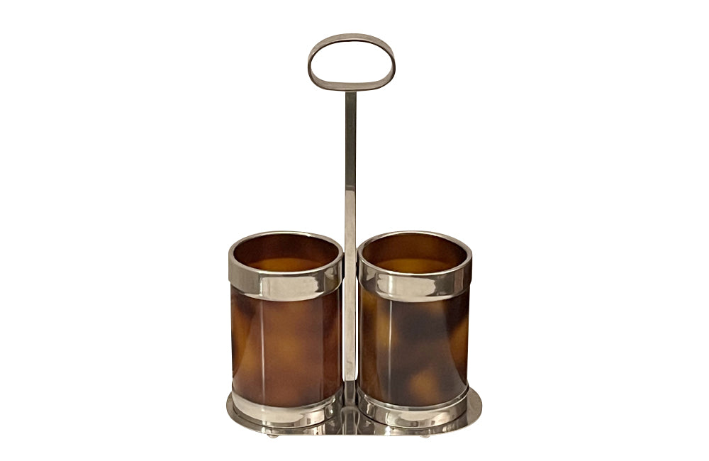 Stylish Mid-Century Italian double bottle holder in faux tortoiseshell lucite and silver plate mounts.