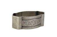20th Century French silverplate napkin ring engraved 'Monsieur' with stylised garland above and below. 