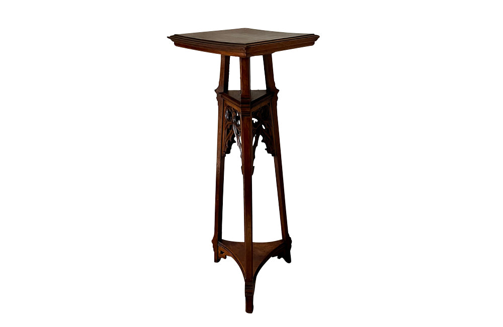 French 19th century walnut sculpture stand with rotating top and a lower shelf all beautifully carved in the Neo-Gothic style