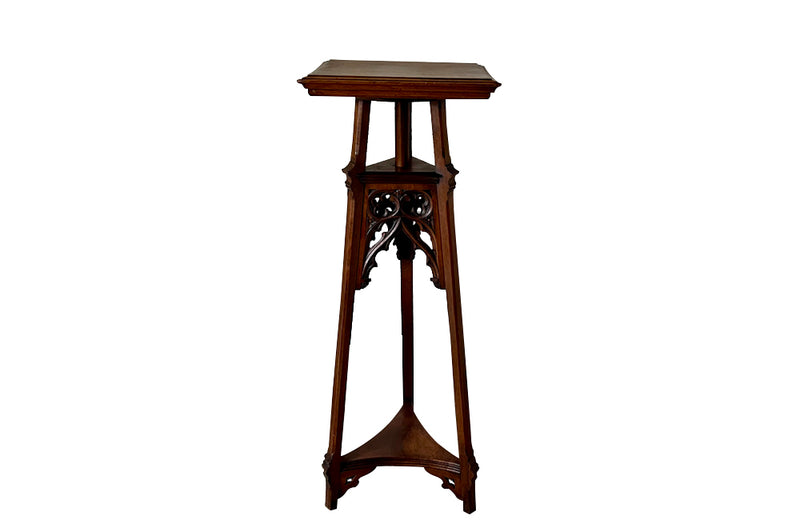 French 19th century walnut sculpture stand with rotating top and a lower shelf all beautifully carved in the Neo-Gothic style