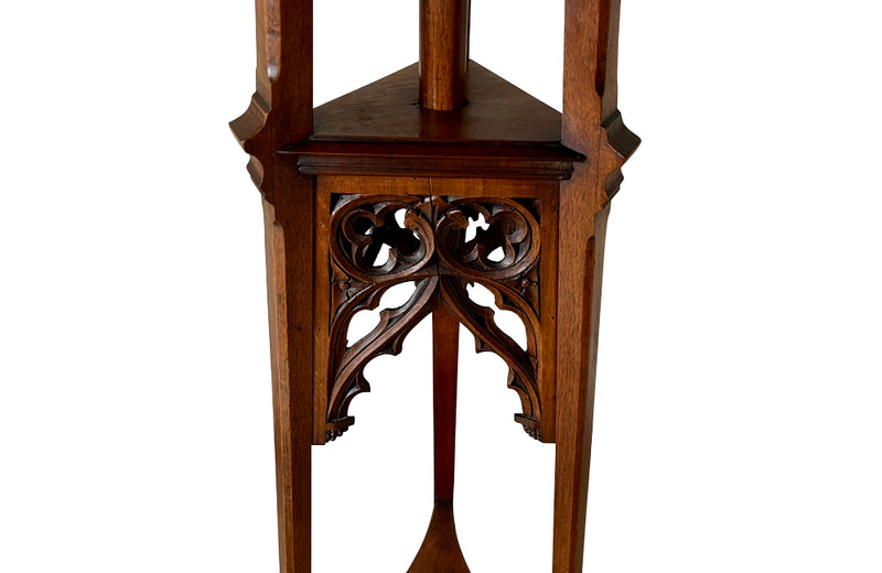 French 19th century walnut sculpture stand with rotating top and a lower shelf all beautifully carved in the Neo-Gothic style