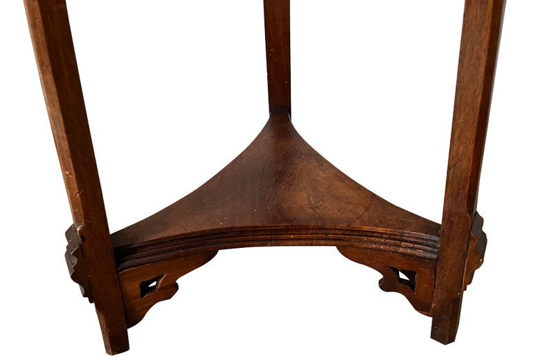 French 19th century walnut sculpture stand with rotating top and a lower shelf all beautifully carved in the Neo-Gothic style