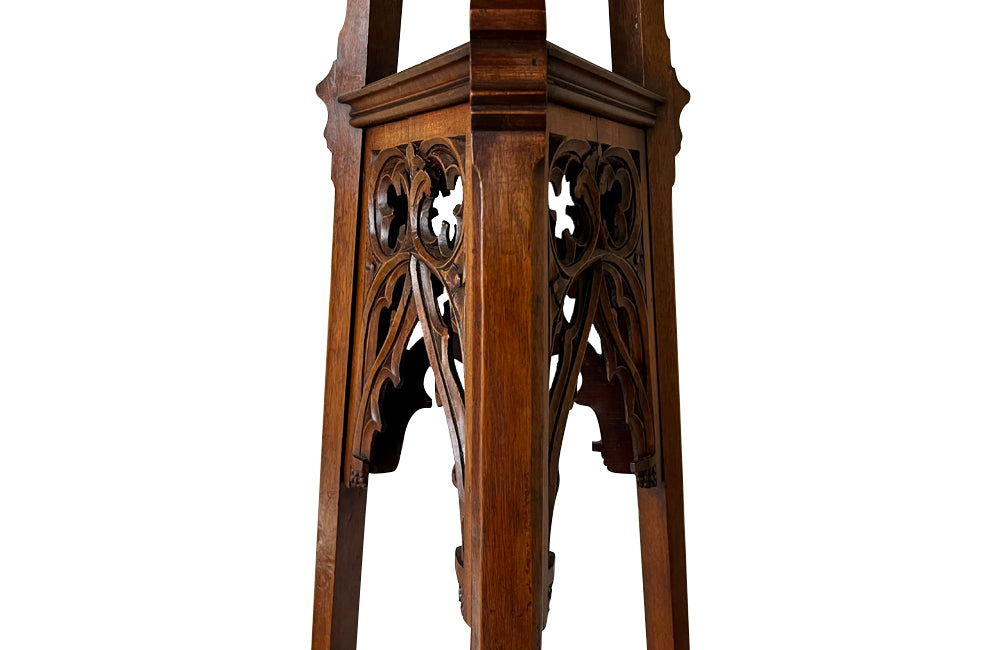 French 19th century walnut sculpture stand with rotating top and a lower shelf all beautifully carved in the Neo-Gothic style