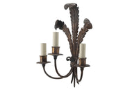 Metal wall light with three tied ostrich feathers and three branched arm bulb holders.