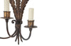 Metal wall light with three tied ostrich feathers and three branched arm bulb holders.