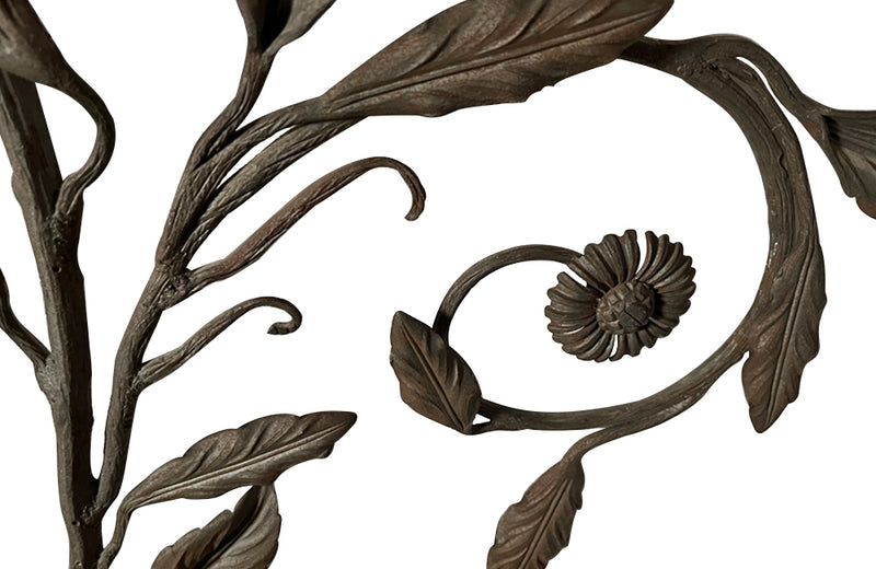 Beautiful pair of early 20th century French large hand wrought iron wall decorations with floral and foliate ornamentation, each in the form of a branching flowering plant.