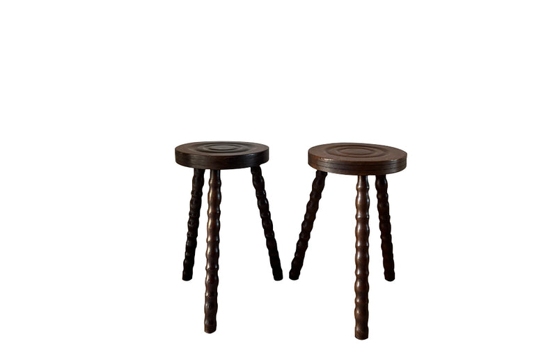 Pair of French vintage tripod stools with bobbin carved legs.