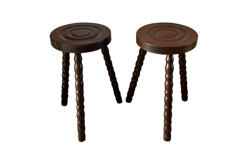 Pair of French vintage tripod stools with bobbin carved legs.