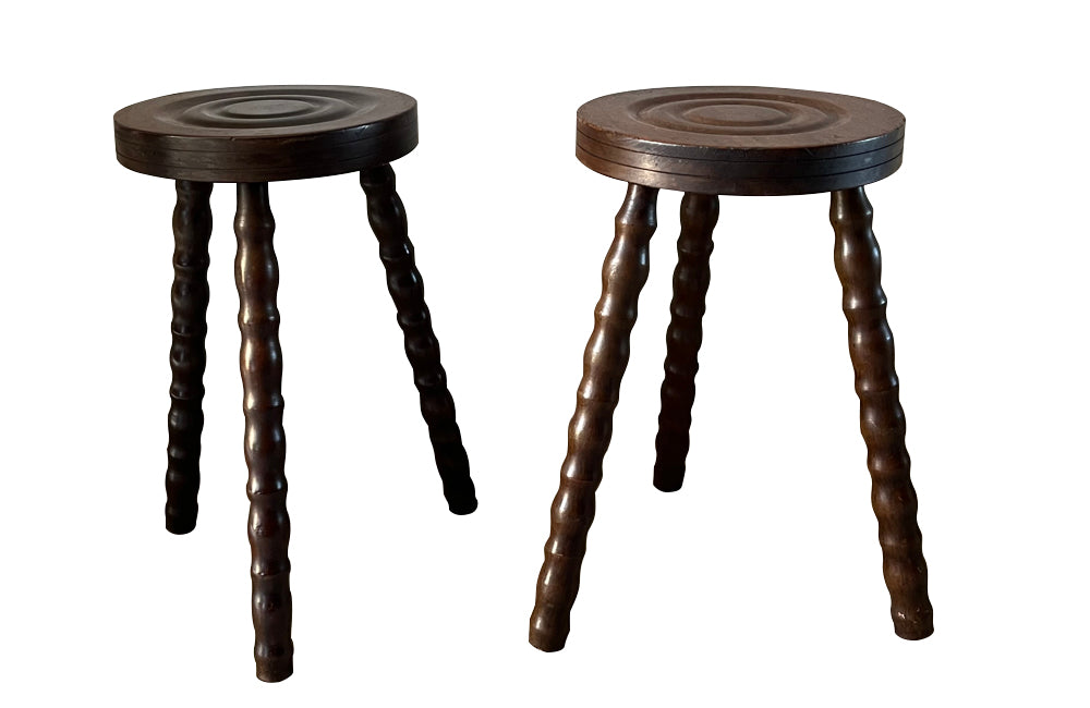 Pair of French vintage tripod stools with bobbin carved legs.