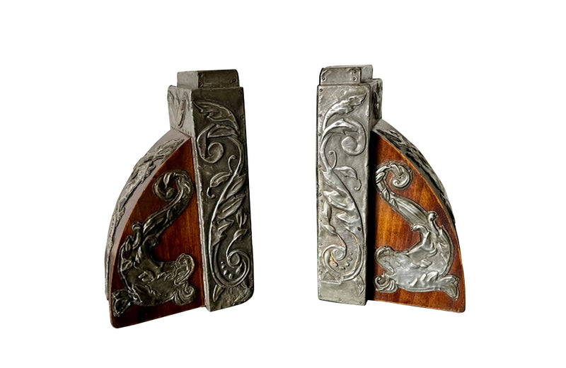 Pair of chinoiserie wood and pressed pewter bookends decorated with dragons, dolphins and foliate motifs circa 1900