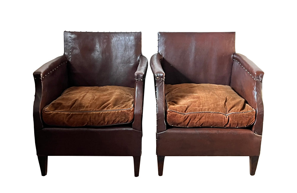 Charming little pair of club chairs with their origianl feather filled cushions circa 1920