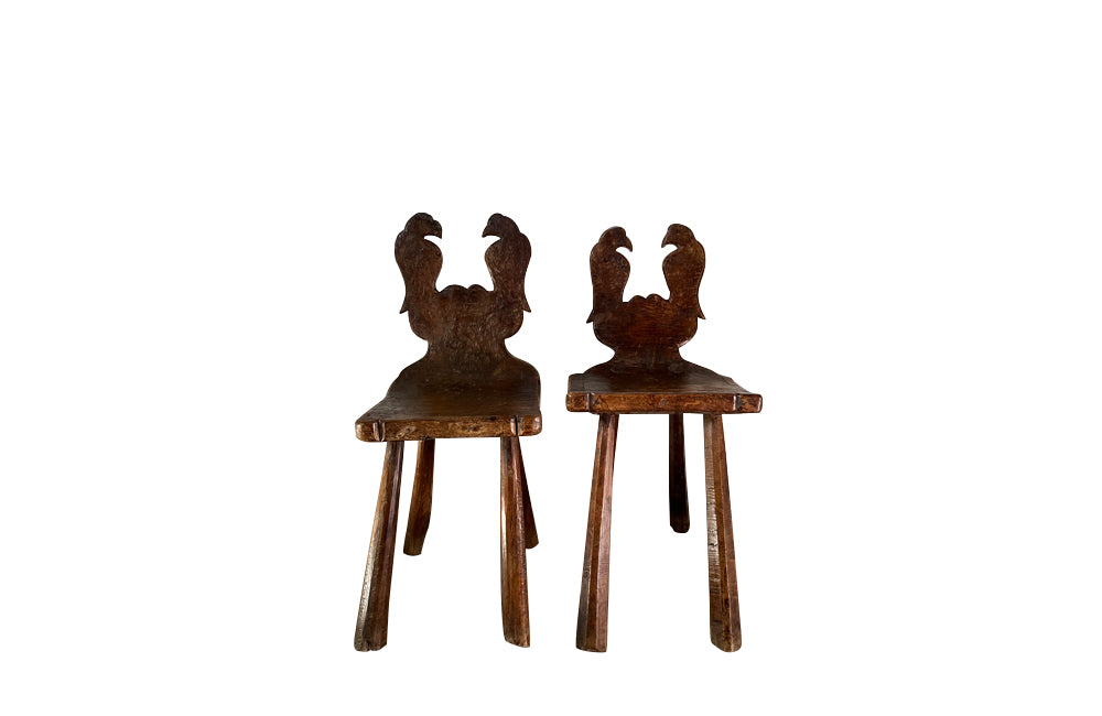 Pair of Spanish rustic hand carved wood chairs with stylised carved birds 