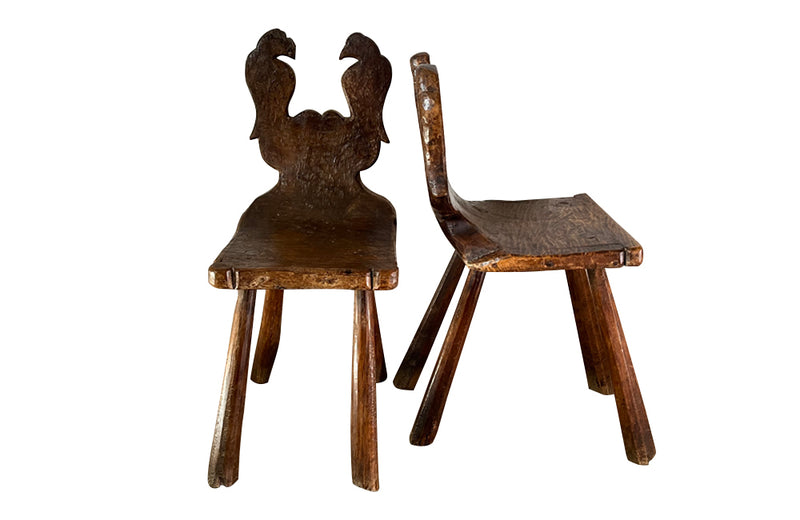 Pair of Spanish rustic hand carved wood chairs with stylised carved birds 