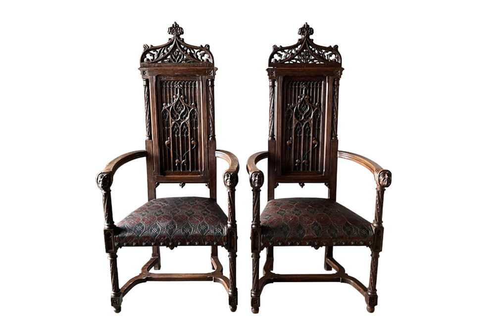 Pair of tall French oak ornately carved armchairs in the Neo-Gothique style.