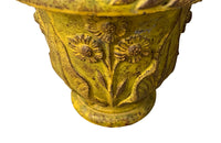 Pair of charming early 20th century French small cast iron urns decorated with daisies and leaves