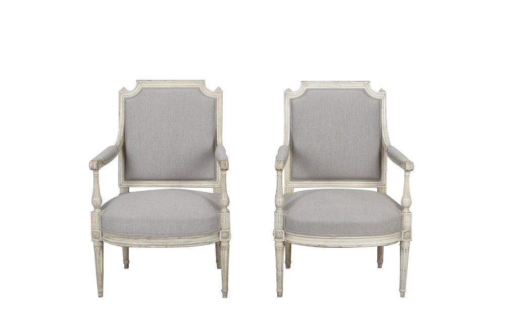 Pair of 19th century, French open 
armchairs in the Neo-Classical style. Reupholstered in linen