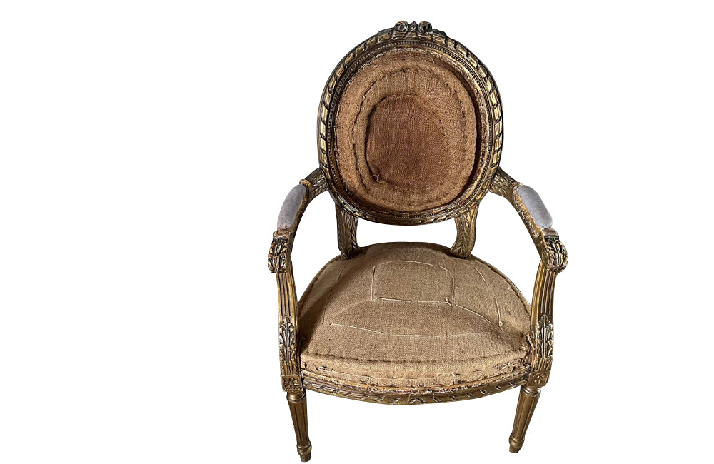 Elegant 19th century pair giltwood carved open armchairs in the Louis XVI style.