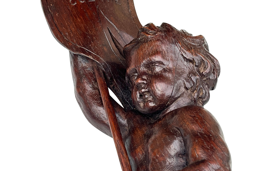 Pair of 19th century French hand carved cherubs bearing pennants inscribed with the names of famous literary figures.