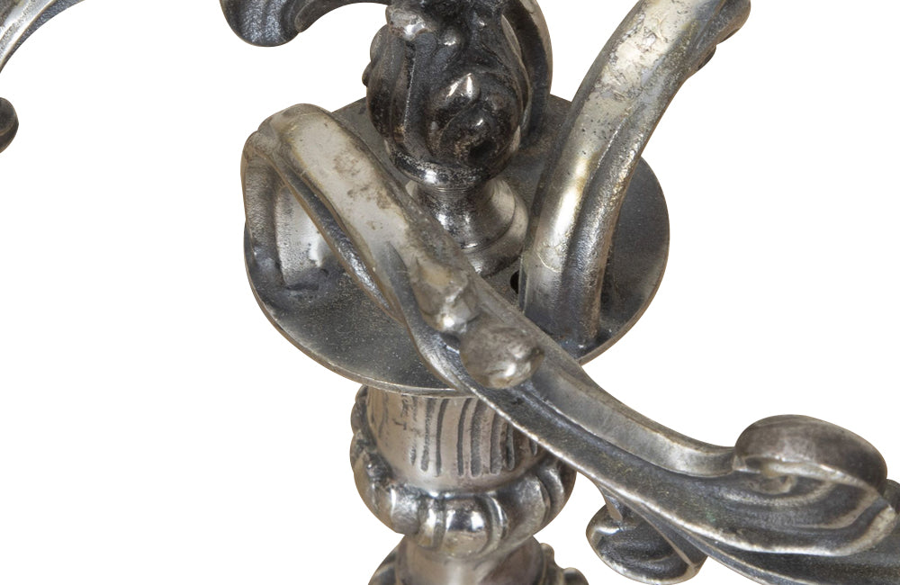 Pair of late 19th Century French worn silver plated candleabras in the Rococo style.