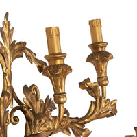 A decorative and elegant pair of 20th Century Italian gilt tole and wood wall lights.