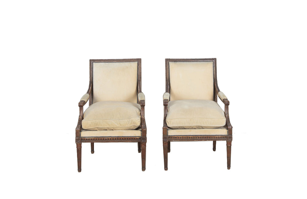 Pair of early 20th Century French Louis XVI Revival open armchairs in the Neo-Classical style.