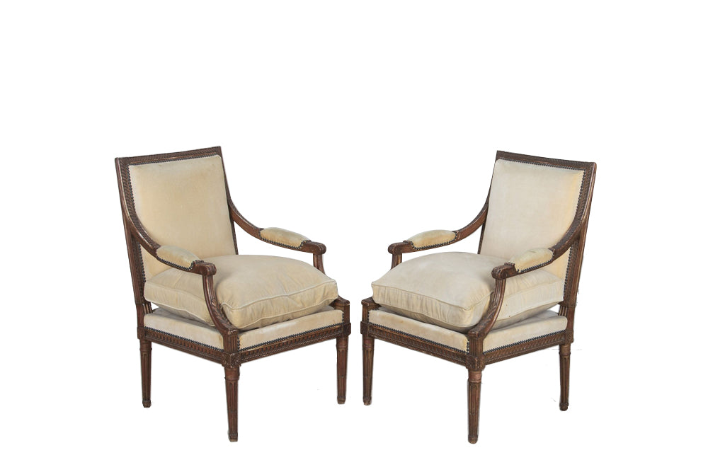 Pair of early 20th Century French Louis XVI Revival open armchairs in the Neo-Classical style.