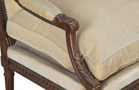 Pair of early 20th Century French Louis XVI Revival open armchairs in the Neo-Classical style.