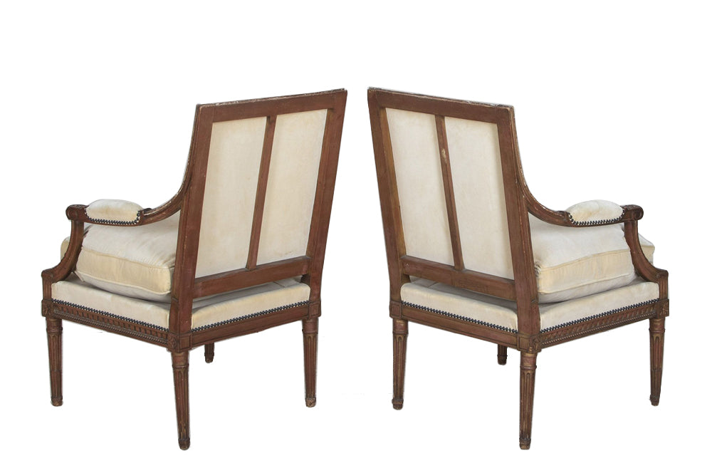 Pair of early 20th Century French Louis XVI Revival open armchairs in the Neo-Classical style.