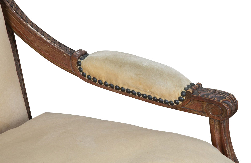 Pair of early 20th Century French Louis XVI Revival open armchairs in the Neo-Classical style.