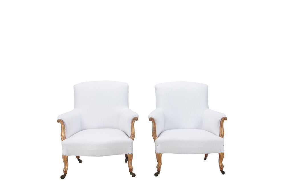 Late 19th century pair of  large French giltwood armchairs in the Louis XV style on casters.