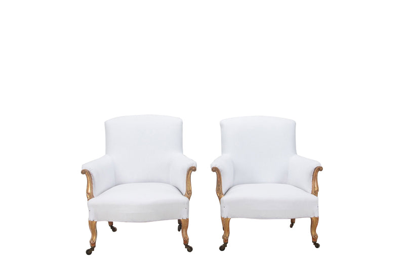 Late 19th century pair of  large French giltwood armchairs in the Louis XV style on casters.