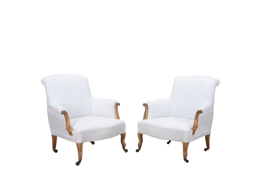 Late 19th century pair of  large French giltwood armchairs in the Louis XV style on casters.