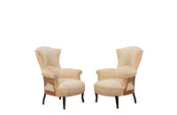 Pair of unusual Napoleon III armchairs with fish tail shaped backs and terminating on ebonised feet.