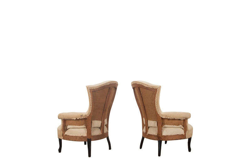 Pair of unusual Napoleon III armchairs with fish tail shaped backs and terminating on ebonised feet.