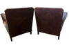 Charming pair of small 1920s French leather club chairs with squared backs and splayed arms.