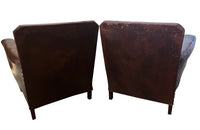 Charming pair of small 1920s French leather club chairs with squared backs and splayed arms.