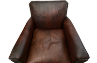 Charming pair of small 1920s French leather club chairs with squared backs and splayed arms.