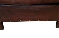 Charming pair of small 1920s French leather club chairs with squared backs and splayed arms.