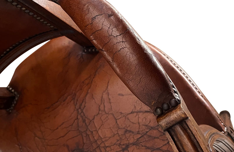 Elegant pair of 20th Century French comfortable worn leather armchairs in the Louis XVI style.