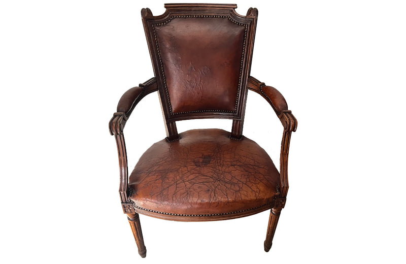 Elegant pair of 20th Century French comfortable worn leather armchairs in the Louis XVI style.